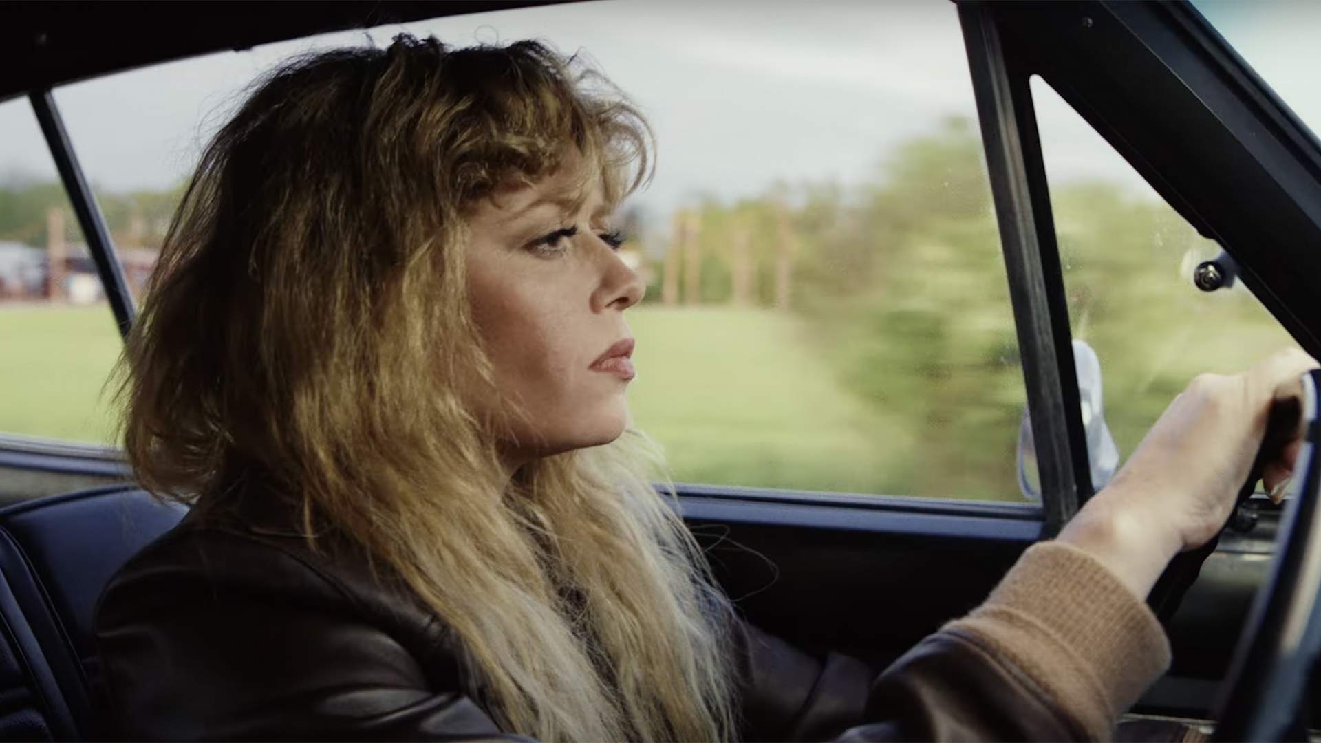 Natasha Lyonne driving a car in the series Poker Face